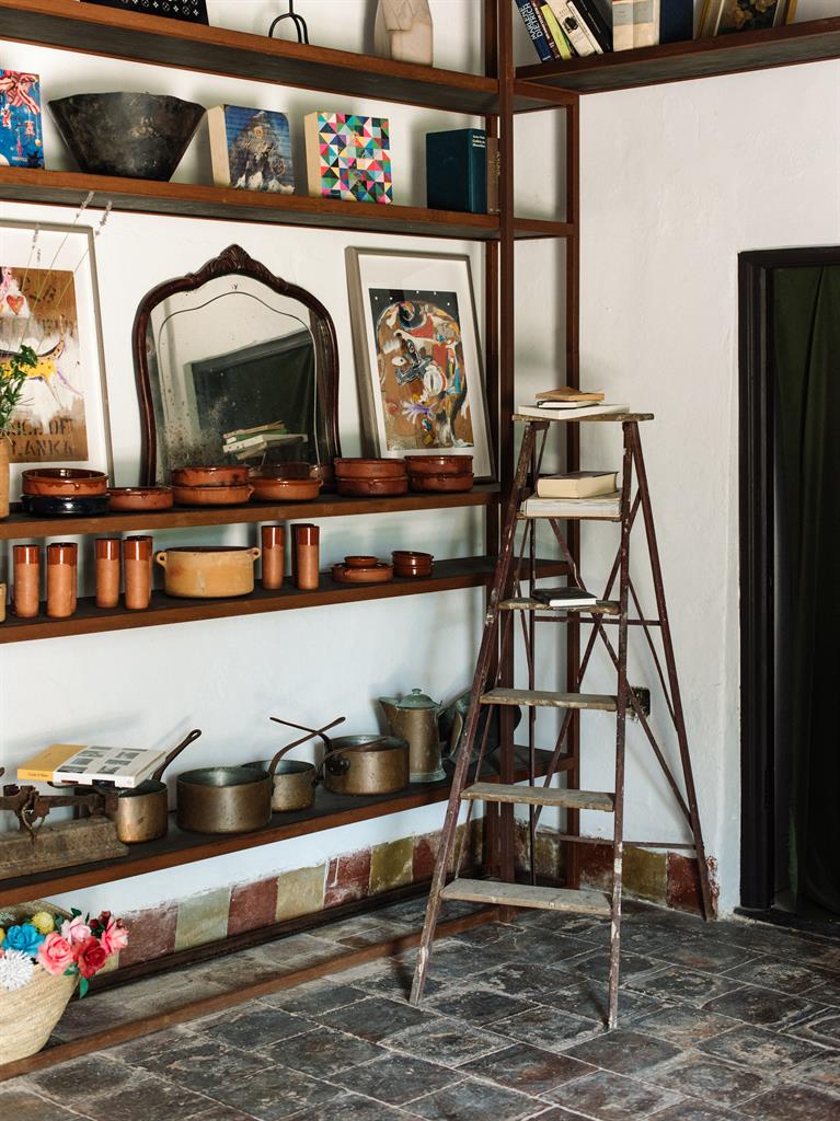 Kitsch corner: Some of Andi’s local finds, above, and a quirky wardrobe space, below