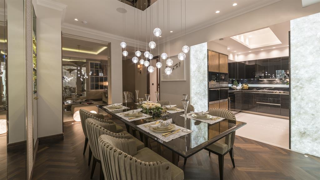 Grandeur: The dining area features herringbone parquet flooring; Below, a bedroom is carpeted in cream silk