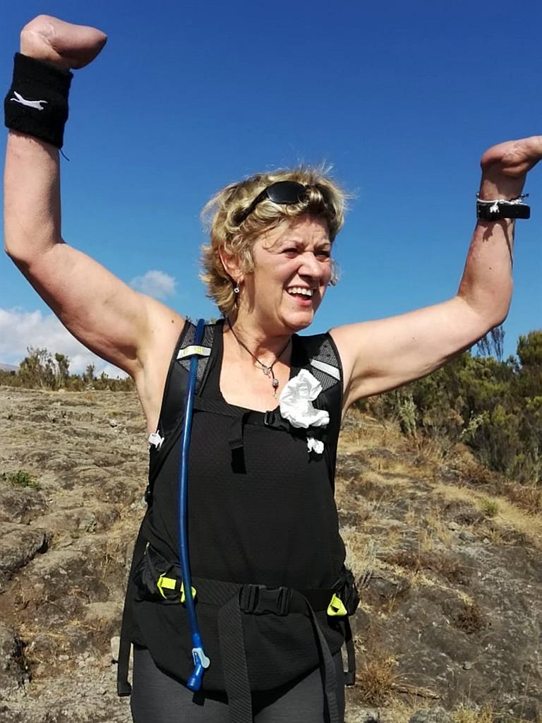Top of the world: Corinne celebrates reaching the summit