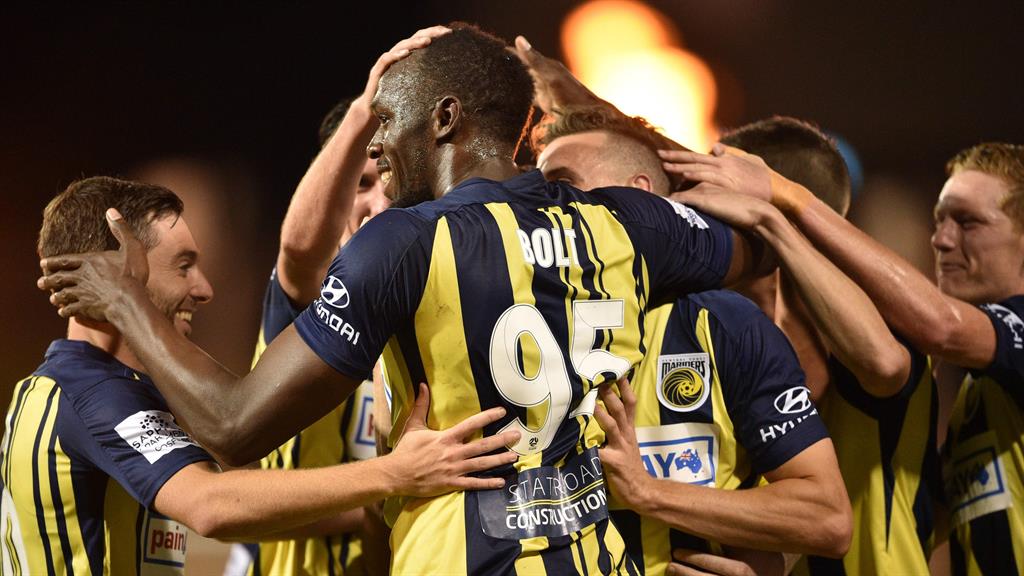 Lightning Bolt: The former sprinter (centre) takes the acclaim of his teammates after scoring his first goal for Central Coast Mariners
