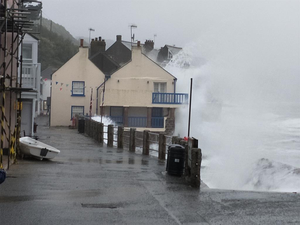 Battered: Waves hit Cawsand, Cornwall, and below PICTURES: PA