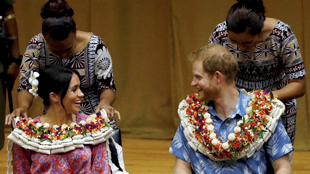 Blooming marvellous: Prince Harry and Meghan were each presented with extravagant floral leis at the university PICTURES: GETTY/SPLASH NEWS/AP