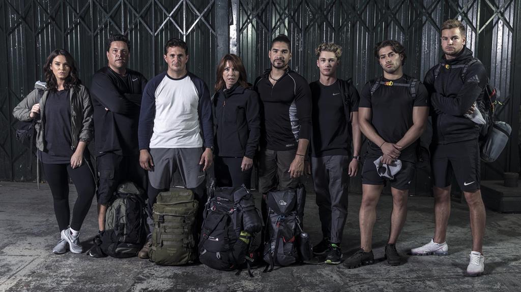 Standing up to cancer: The eight ‘fugitives’ - (left to right) Vicky Pattison, Dom Joly, Johnny Mercer, Kay Burley, Louis Smith, AJ Pritchard, Kem Cetinay and Chris Humes - all raised money for charity by taking part