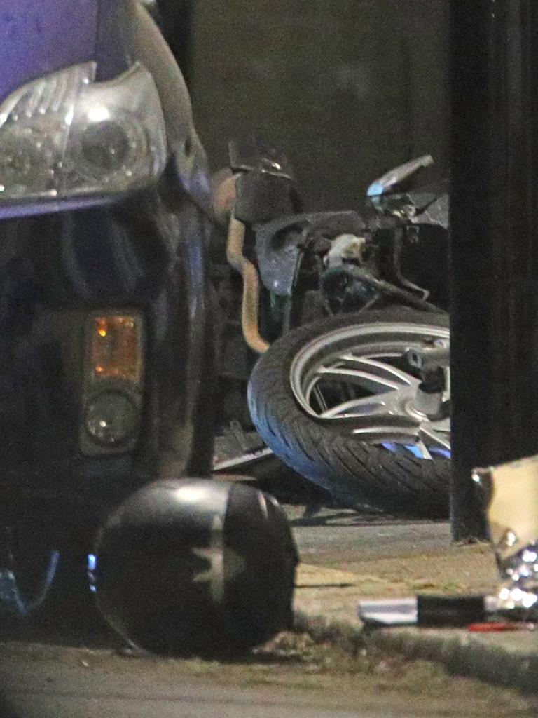 Murder hunt: The crumpled moped and a helmet lie in the street in Leyton, east London, where 14-year-old Jayden died PICTURES: PA