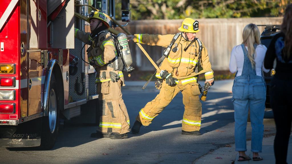Ruse: The firefighters arrive to put out the fake inferno (below)