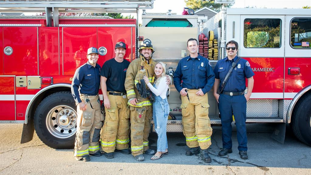 Good sports: Maddison with Zach and his fire department colleagues