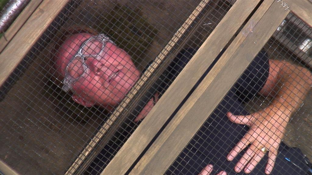 Zoning out: Have-a-go Harry caged for a bushtucker trial PICTURE: ITV/REX