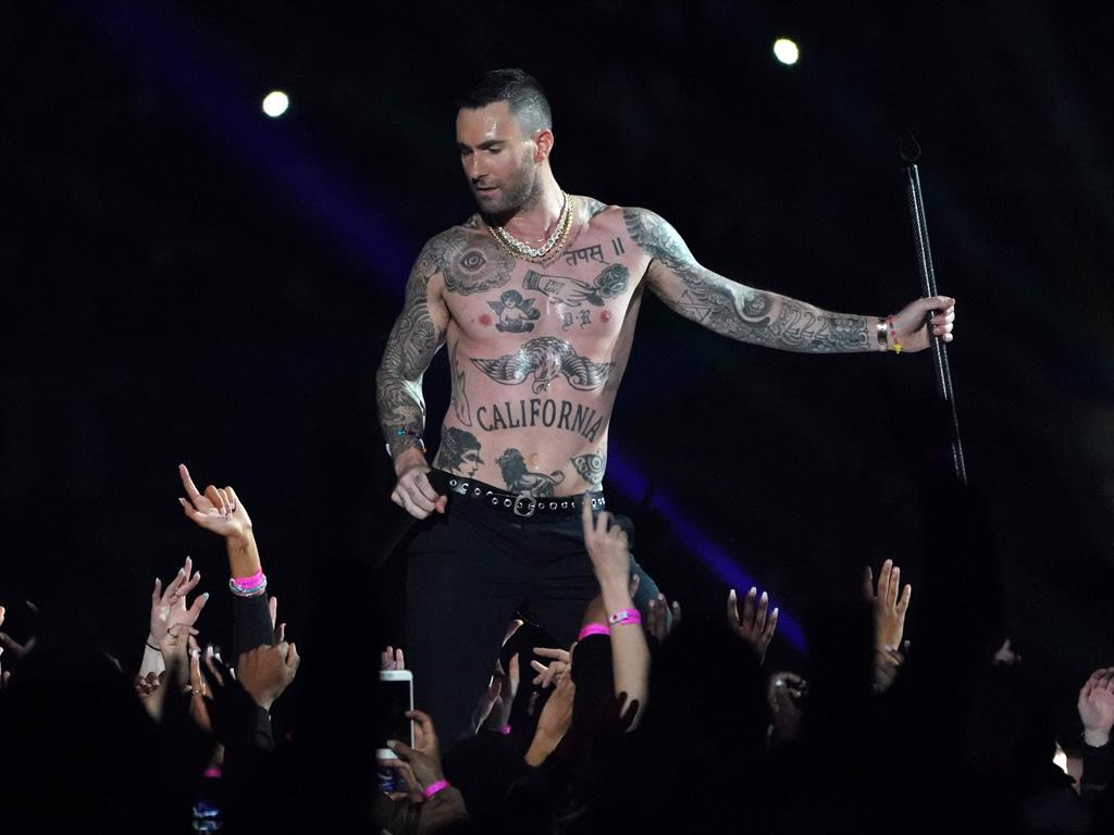 Topping things off: Singer Adam Levine strips to the waist during the show PICTURE: GETTY