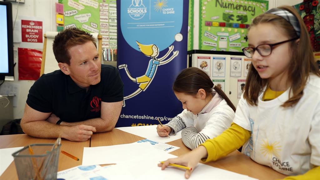 Having an impact: Eoin Morgan with schoolchildren during the launch of the 'Welcome to Our Area' and 'Playground Pundits' projects as part of the ICC Cricket World Cup Schools Programme at Grafton Primary School in London PICTURE: GETTY
