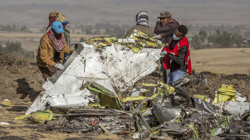 Grim task: Workers sift through the wreckage of the Ethiopian Airlines jet PICTURE: AP