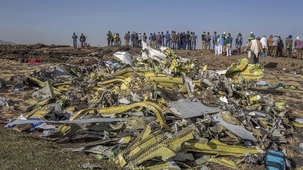 Disaster: Wreckage is piled up at the crash scene of an Ethiopian Airlines flight crash near Bishoftu, south of Addis Ababa PICTURE: AP