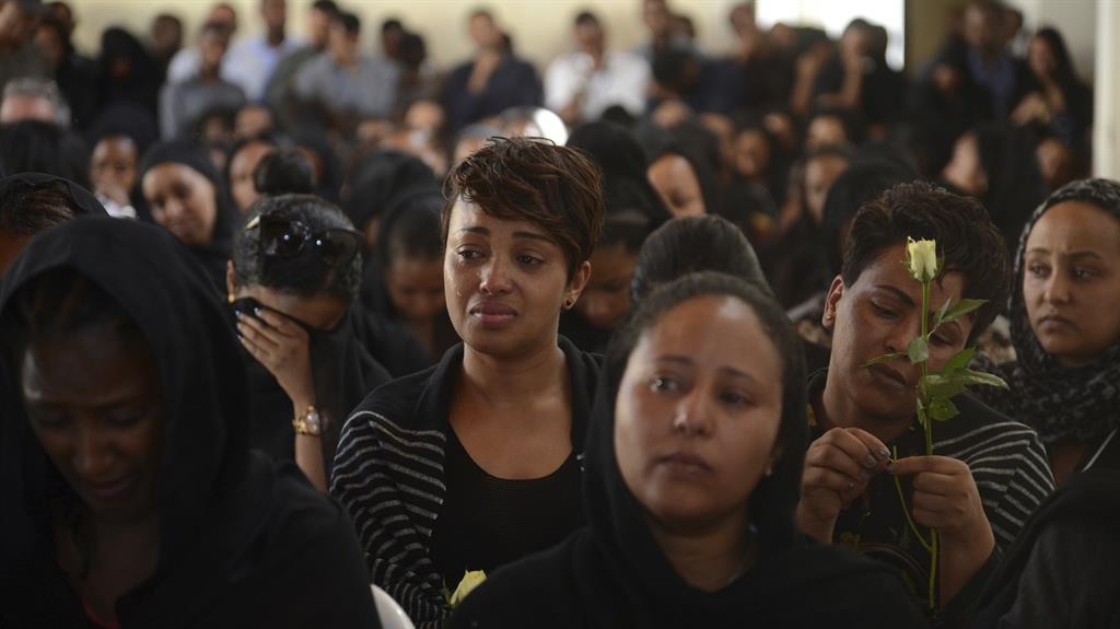 Shock and grief: Mourners attend a memorial service held by an association of Ethiopian airline pilots in Addis Ababa PICTURE: AP