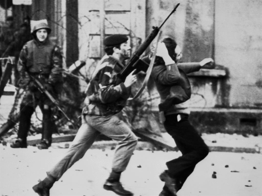 Brutal: A British soldier is pictured dragging a Catholic protester