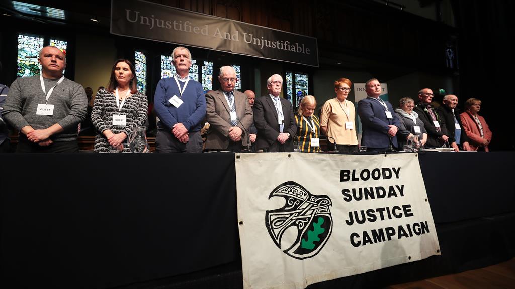 Remembrance: Families hold a minute's silence during the press conference at the Guildhall in Derry PICTURE: PA