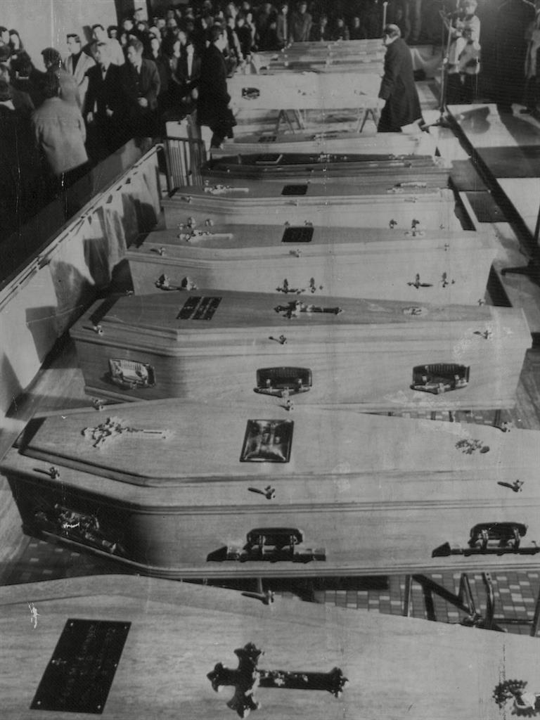 Aftermath: Mourners during a requiem mass following the killings PICURE: REX