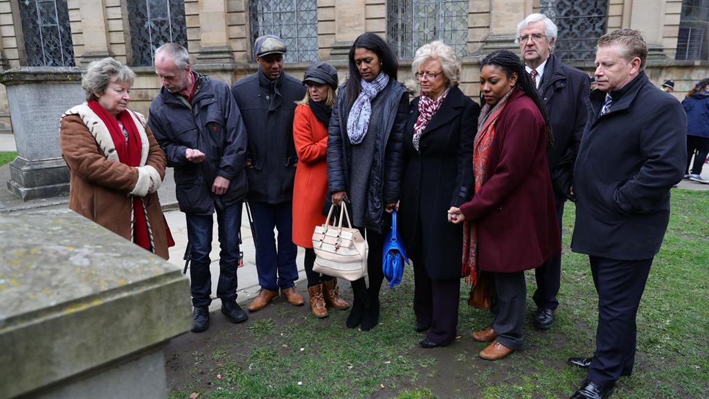 Loss: Families look at the memorial to victims after the conclusion of the inquest PICTURE: PA
