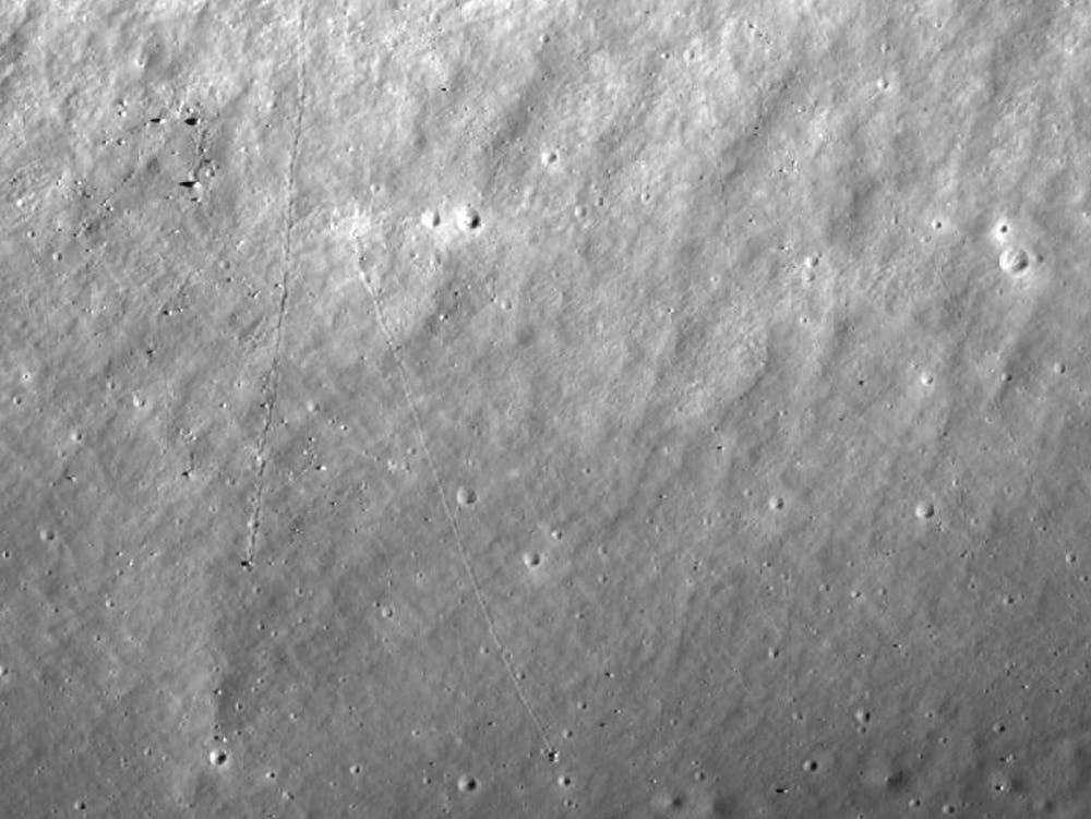 The tracks of two boulders that rolled downhill towards the Apollo 17 landing site. Each boulder is at the southern end of its track, where it casts a shadow to its left PICTURE: NASA/GSFC/ARIZONA STATE UNIVERSITY
