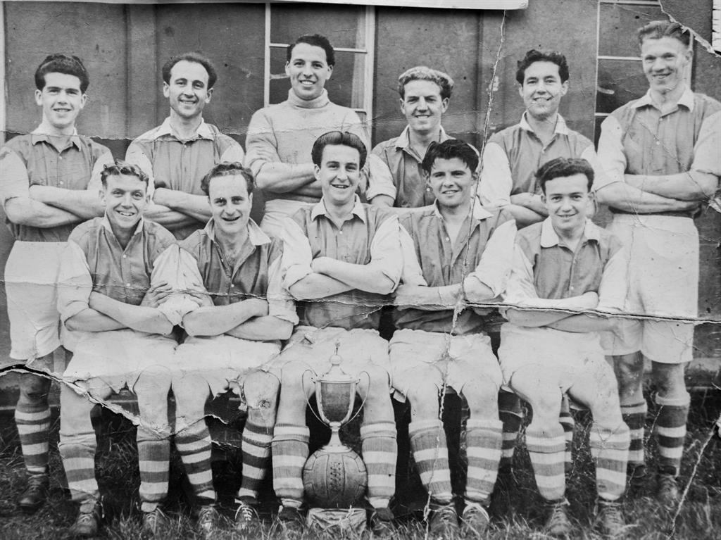 Keen sportsman: Glyn (front row, second from left) played as a striker for his local football team