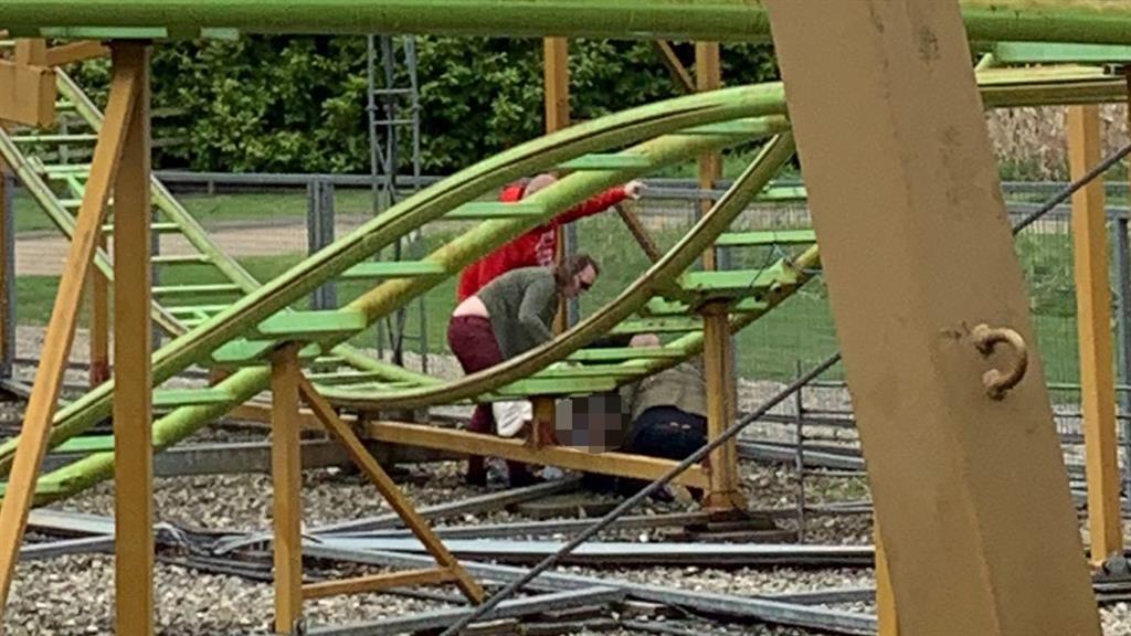 Horror: People rush to the boy after he was seen to fall from the Twister ride PICTURE: GETTY
