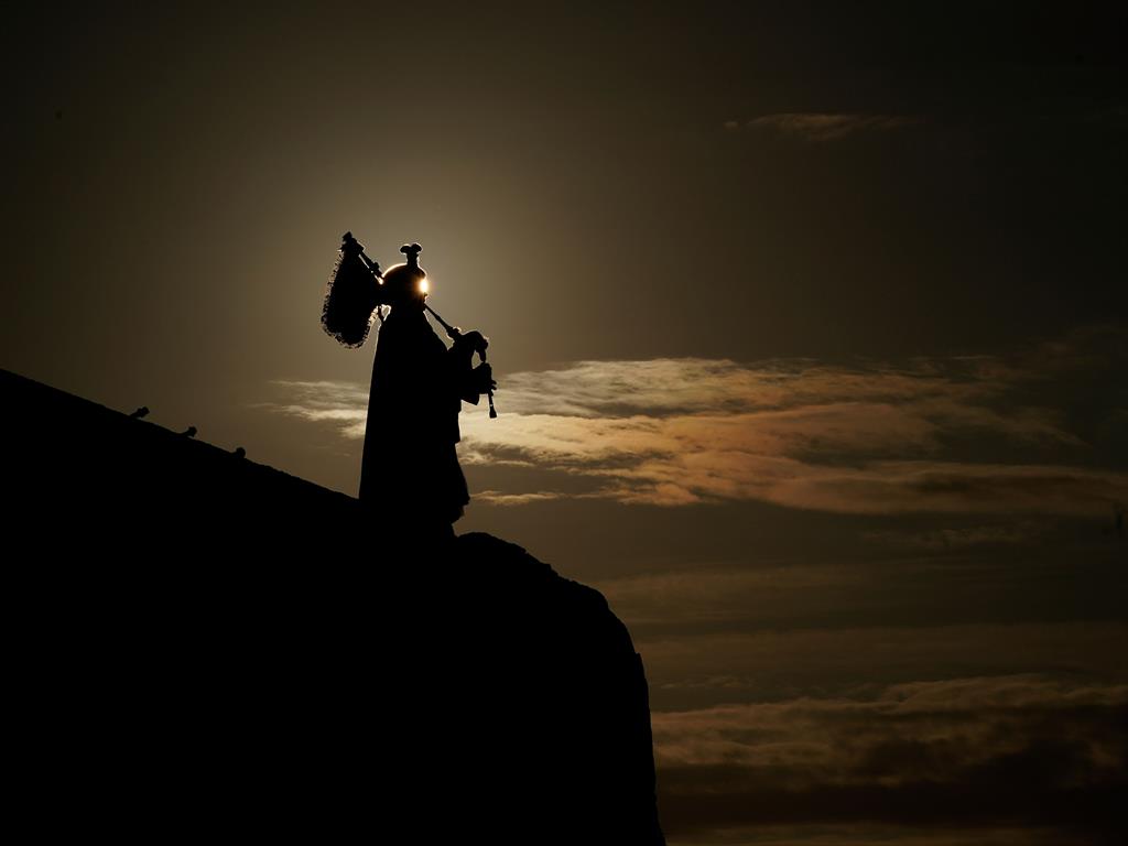 Early morning: A lone Scottish piper plays at Mulberry harbour to mark the moment the D-Day landings began PICTURE: GETTY