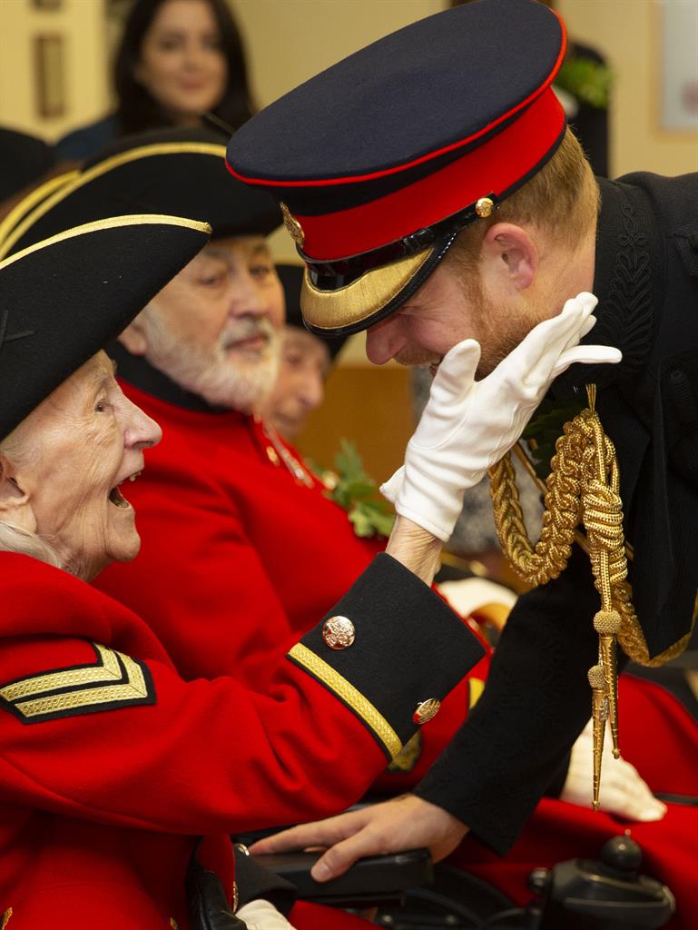 Honoured: Harry with a Chelsea Pensioner PICTURE: PA