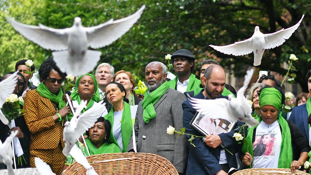 Poignant: White doves are released during a memorial service in memory of lives lost PICTURE: PA