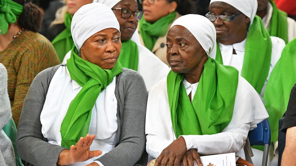 No words: Members of the congregation during a service of remembrance at St Helens church in London PICTURE: PA