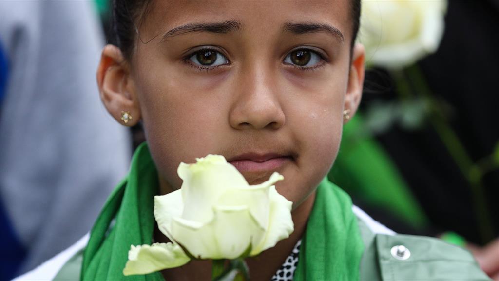 Remembrance: A child pays her respect to those lost in the tragedy PICTURE: SWNS