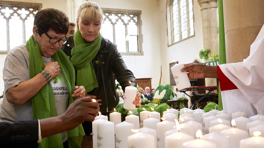 Remembering those they lost: Family and friends light candles in honour of the victims who died in the tragedy PICTURE: GETTY