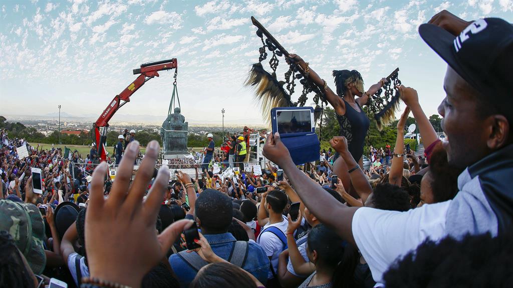 Students celebrate as the sculpture of Cecil John Rhodes is removed from the University of Cape Town in April 2015 PICTURE: EPA/NIC BOTHMA