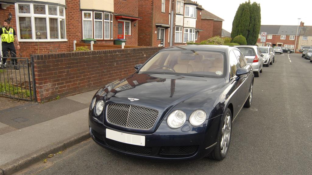 Driving in style: A Bentley GT Continental parked outside one of the addresses linked to the gang