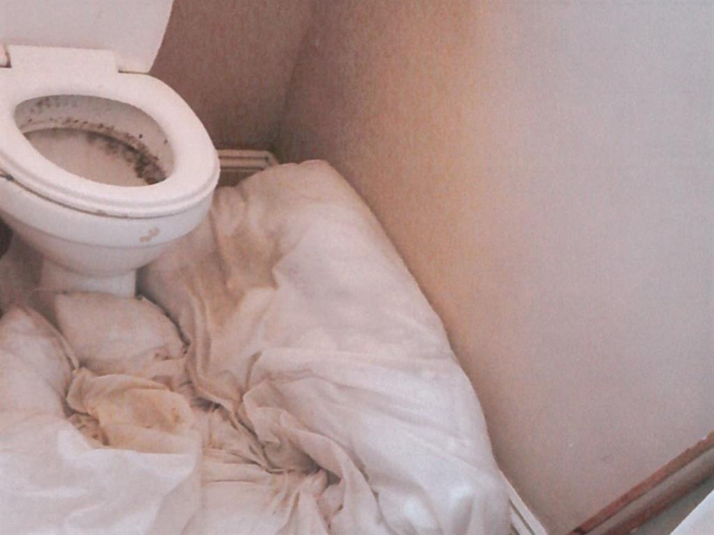 Living in squalor: One house’s leaky toilet had to be plugged with an old duvet