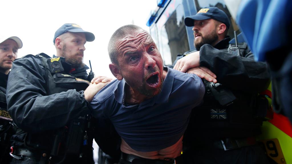 Arrest: A protester is detained by police after scuffles broke out outside Parliament PICTURES: GETTY/PA