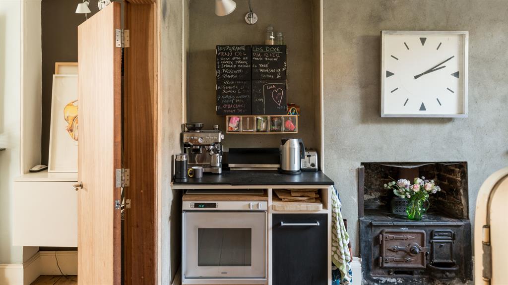Old and new: The kitchen (above) has an industrial feel, and its original stove; there’s also plenty of room for display (below)