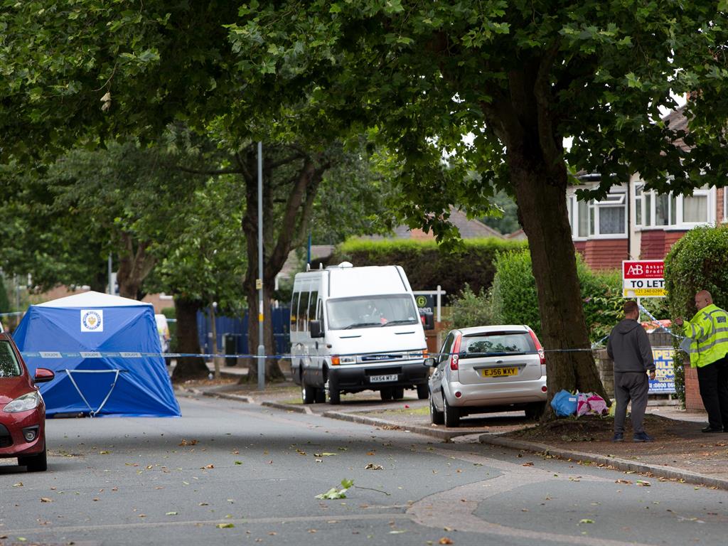 Respects: Floral tributes have been laid at the scene in Goosemoor Lane, Erdington PICTURE: SWNS