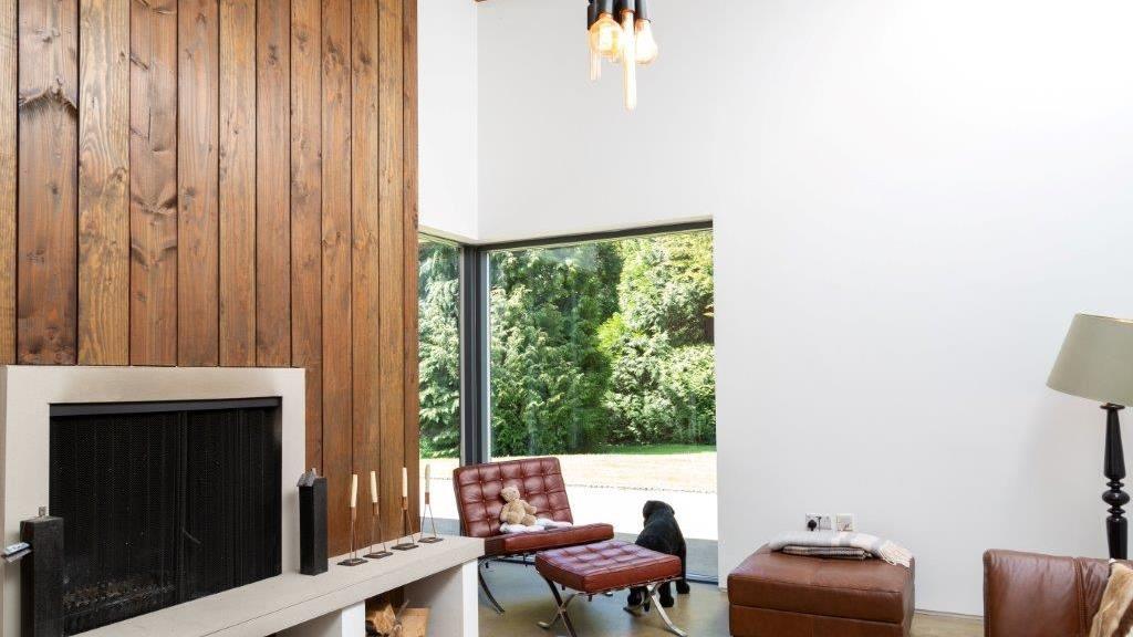 Fir coat: The wood trim adds warmth to the living room. Below: The kitchen features a secret larder