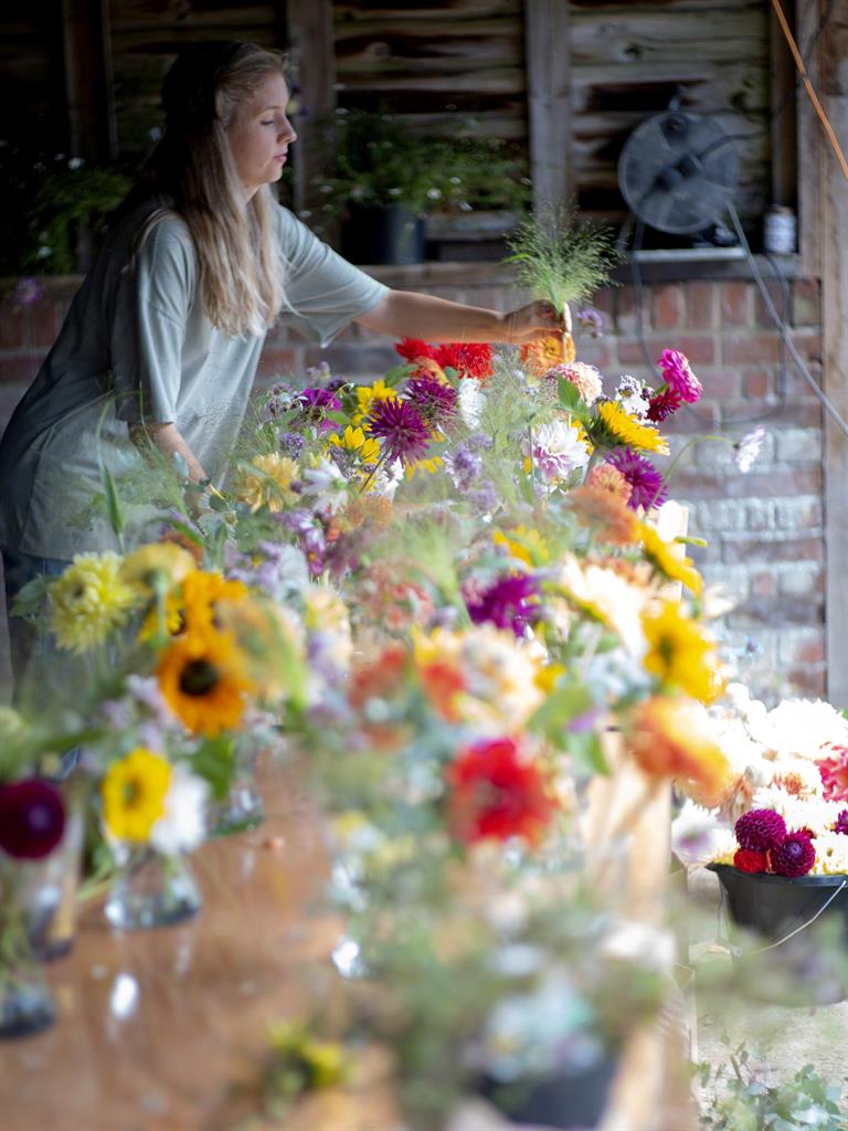 Finishing touches: Aimee arranges the flowers ahead of her big day PICTURES: SWNS
