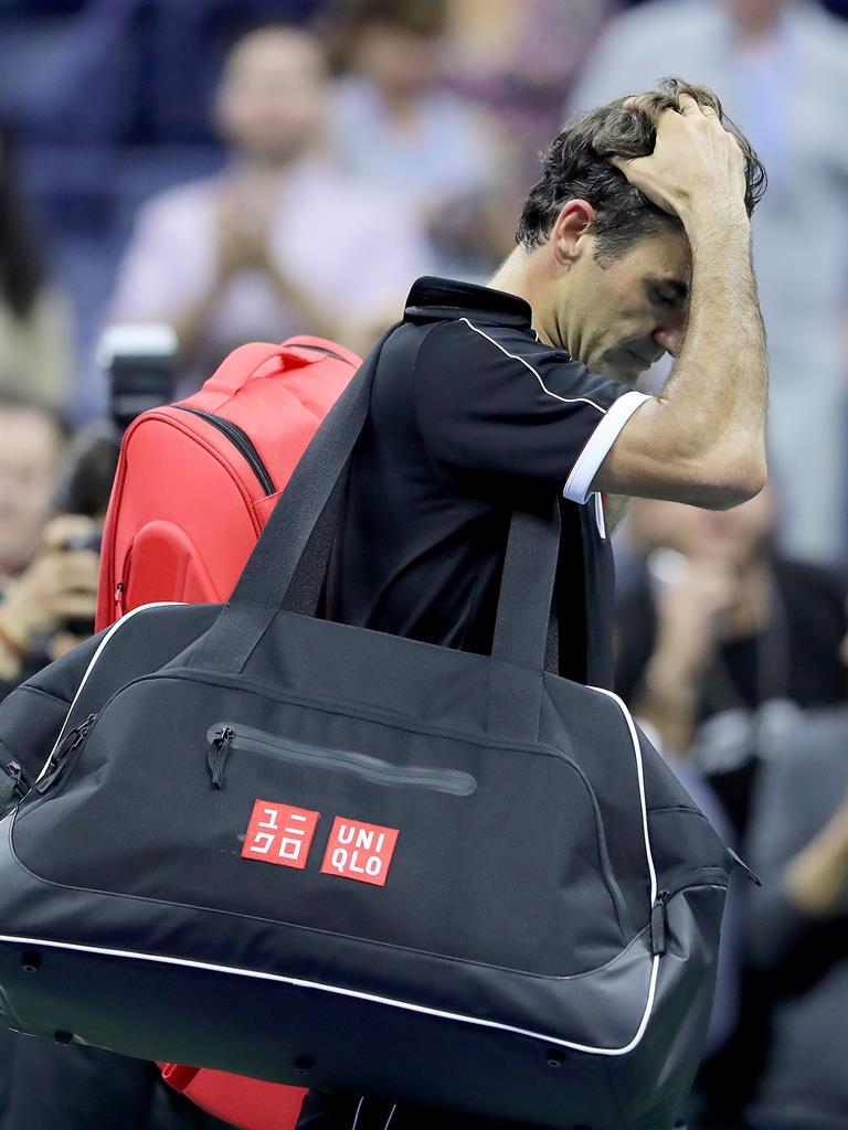 Low point: Federer walks off court after the defeat PICTURES: AP/GETTY
