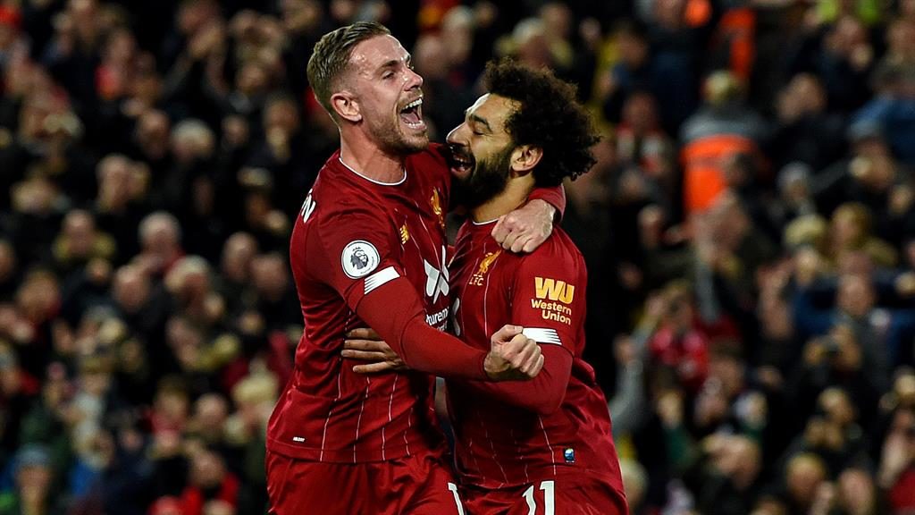 Red hot Henderson, who hit Liverpool’s equaliser hugs Salah after his decisive penalty