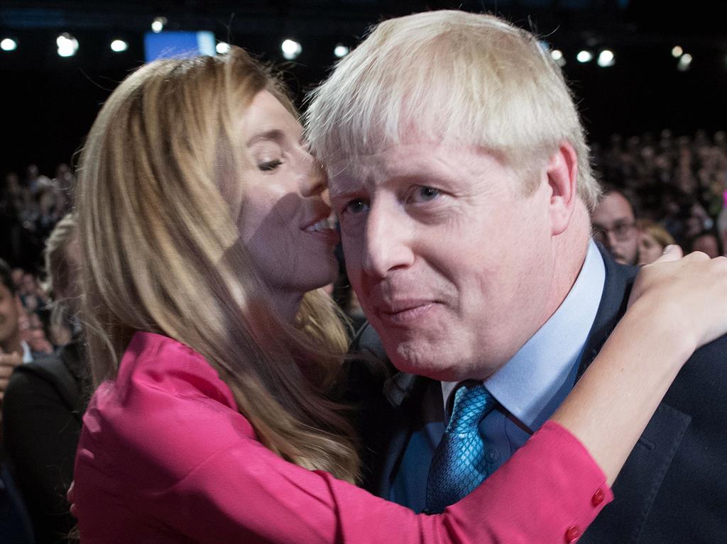 That's my boy: Boris is embraced by his partner Carrie Symonds after he delivered his keynote speech PICTURES: GETTY/PA