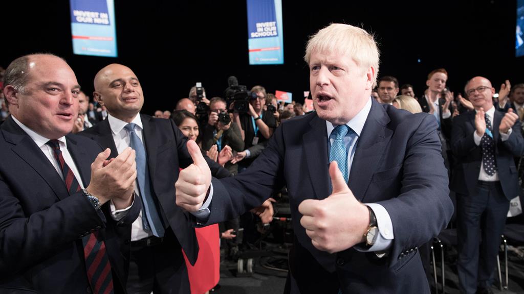 Faithful rallied: Boris Johnson gives a thumbs up as he leaves the stage