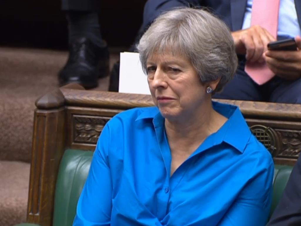 Back seat: Theresa May, who quit as PM after failing to get her Brexit deal through, listens to Mr Johnson in parliament