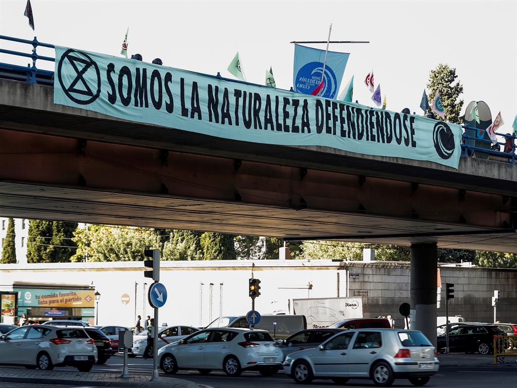 Time for change: Activists with a banner reading 'We are Nature defending itself' block traffic in Madrid, Spain PICTURE: EPA