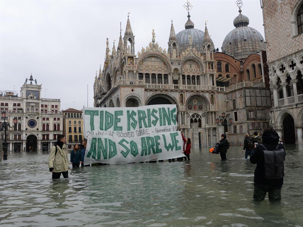 Hard to ignore: Environmentalists hold a banner in the midst of Venice's worst flood in 53 years PICTURE: EPA