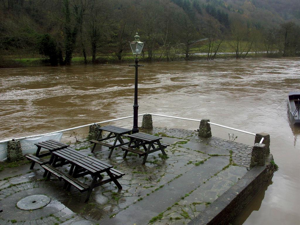 Washed away: The swollen River Wye, as viewed from outside the Ye Olde Ferrie Inn, about to burst its banks in Symonds Yat, Herefordshire