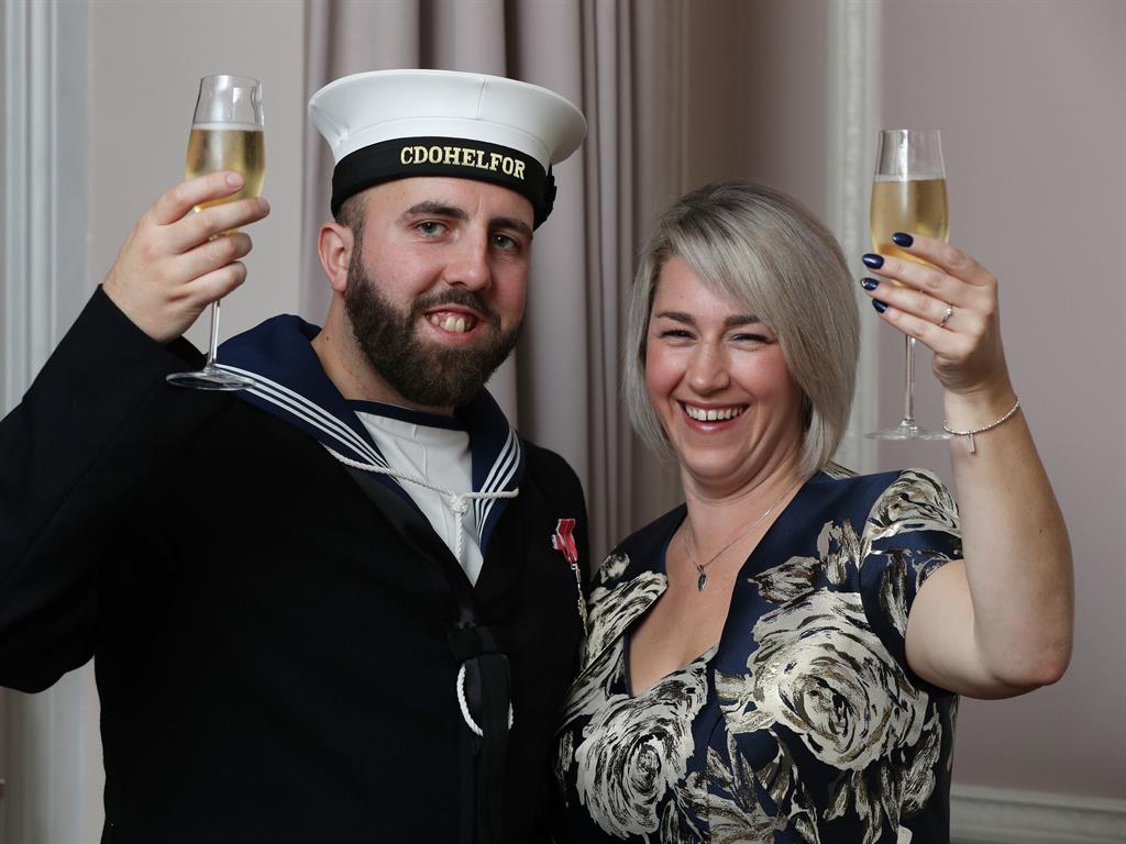 Cheers: The happy couple celebrate with a glass of bubbly