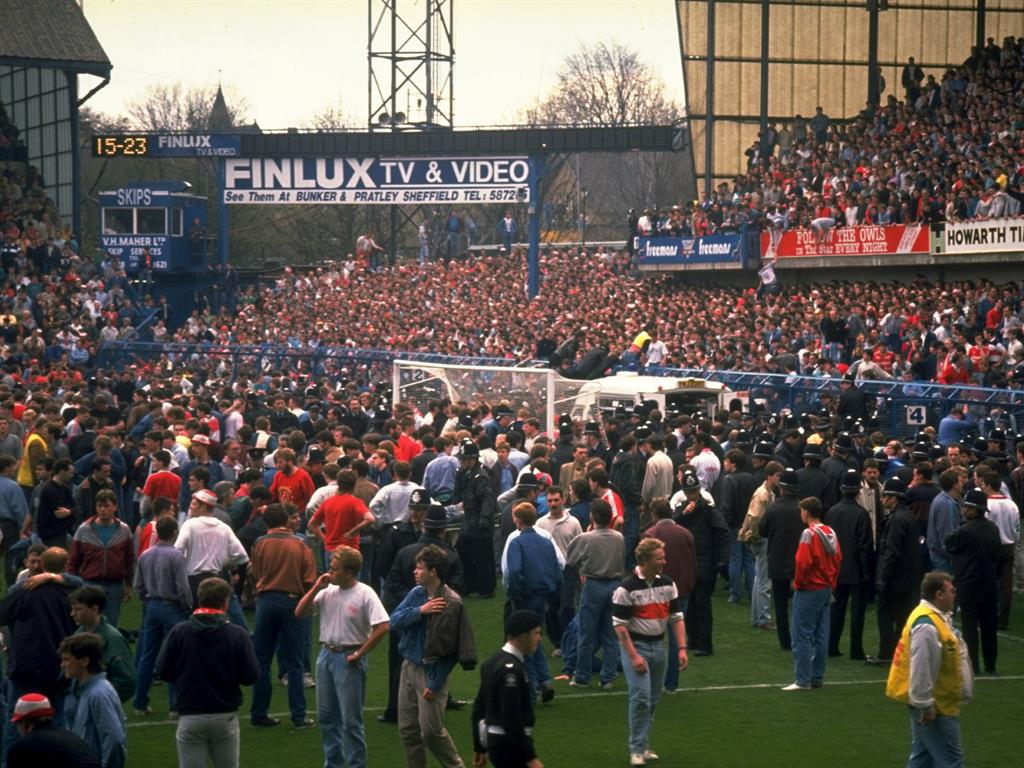 Escape route: Liverpool supporters spill onto the Hillsborough pitch PICTURE: GETTY