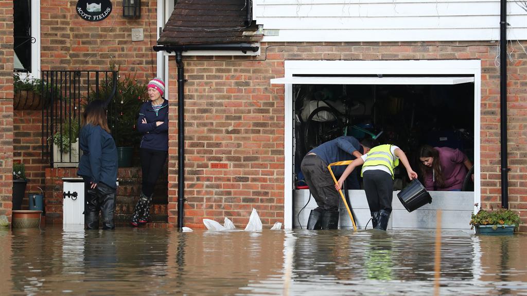 Desperate battle: Residents attempt to stop floodwater entering their home in Yalding, Kent PICTURE: PA