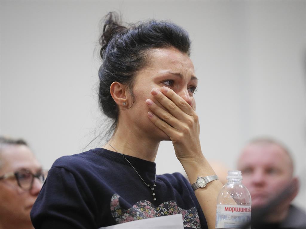 Shock: An employee of the Ukraine International Airlines (UIA) company reacts during a press conference at Boryspil International Airport in Kyiv PICTURE: EPA