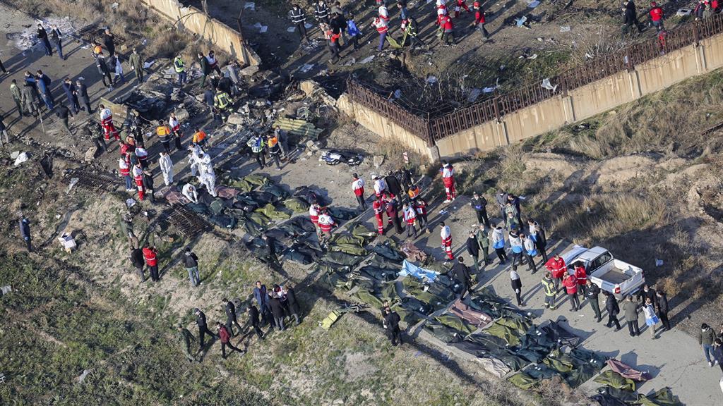 Scene of horror: The crash site as emergency services workers and members of the International Red Crescent work next to the wreckage PICTURE: EPA